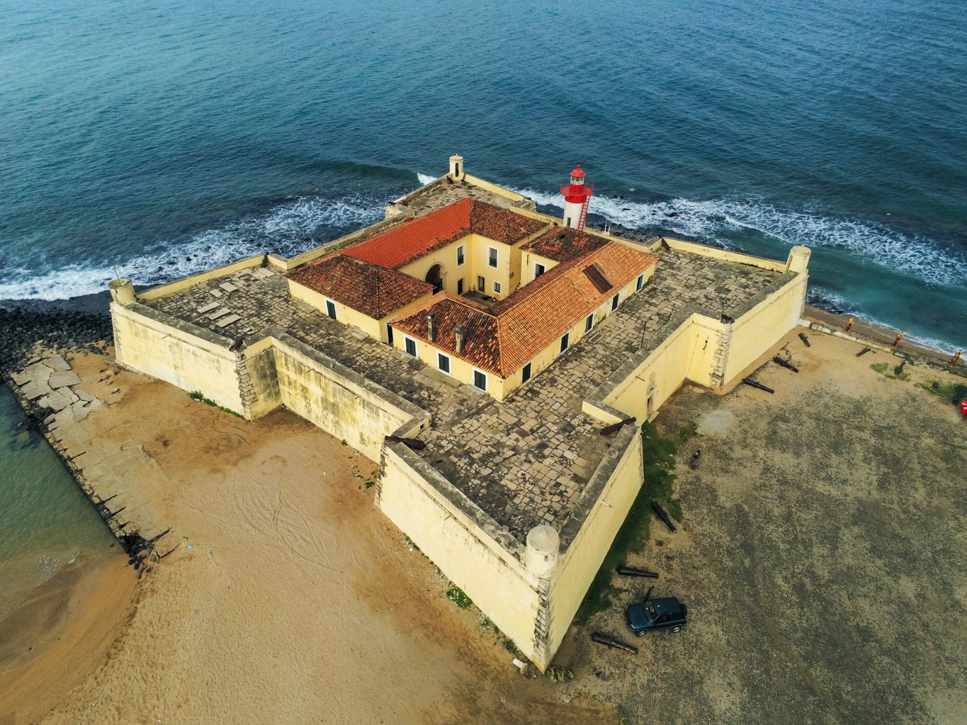 Aerial view of Forte de São Sebastião, the star-shaped fort and red lighthouse on Ana Chaves Bay