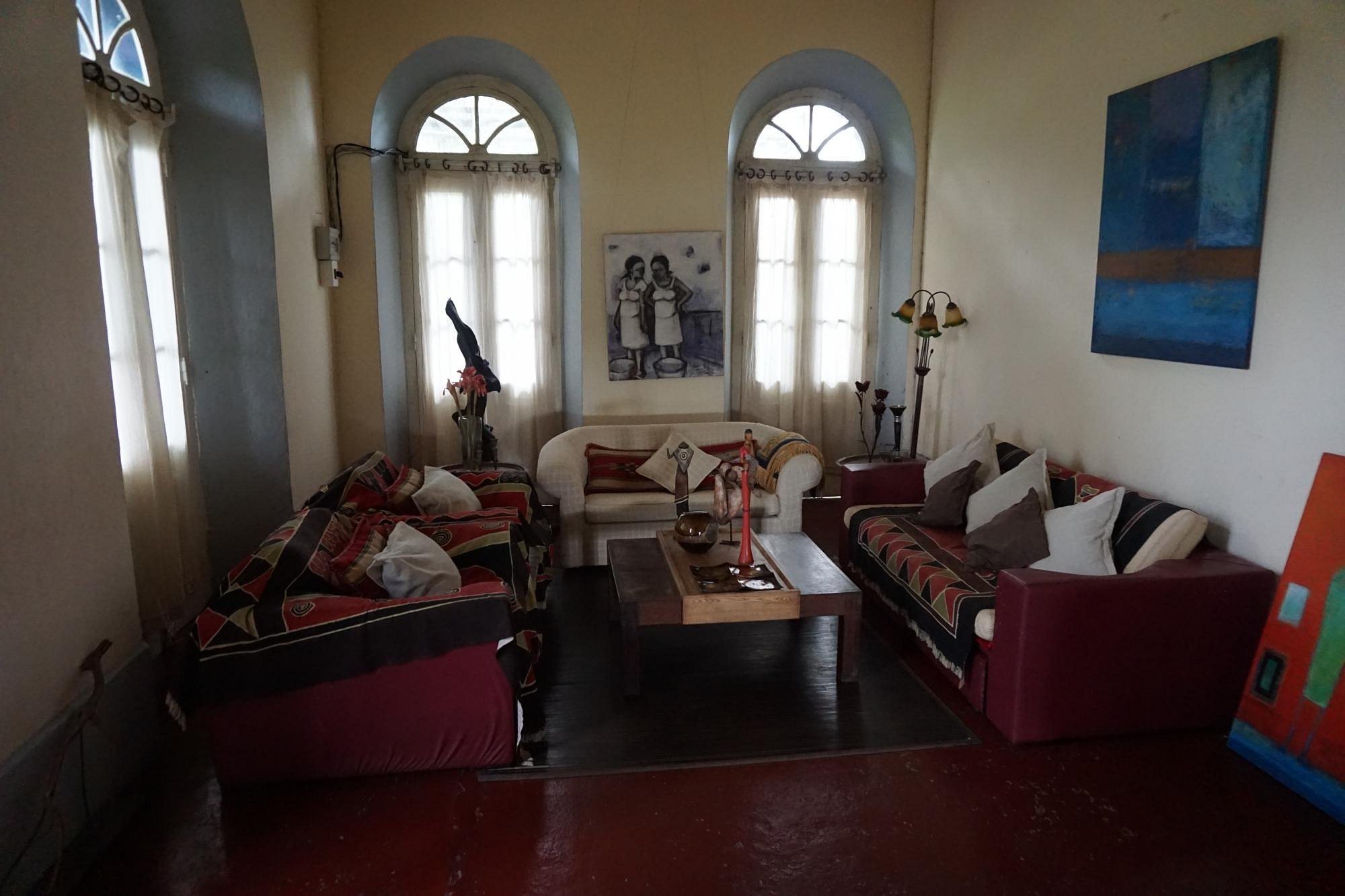Grand colonial sitting room with local art at Roça São João dos Angolares, São Tomé