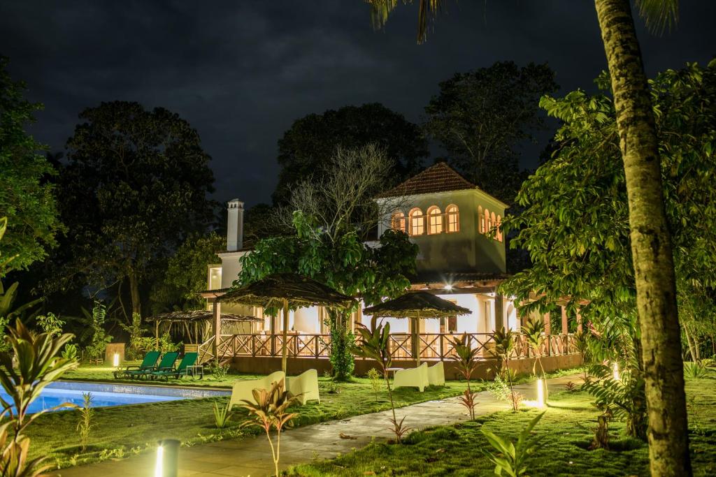 The ecolodge and pool lit at night at Roça Santo António, central São Tomé