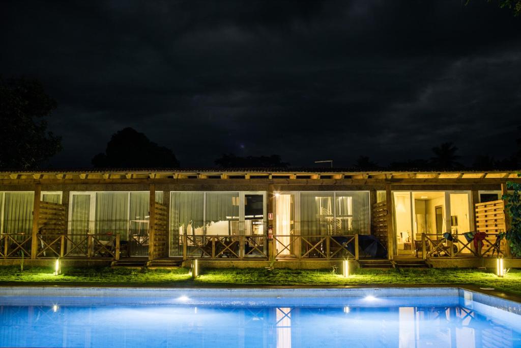 Pool lit at night beside the rooms at Roça Santo António Ecolodge, São Tomé