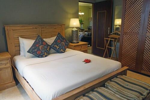 Guest room with hardwood bed and island textiles, Belo Monte, Príncipe