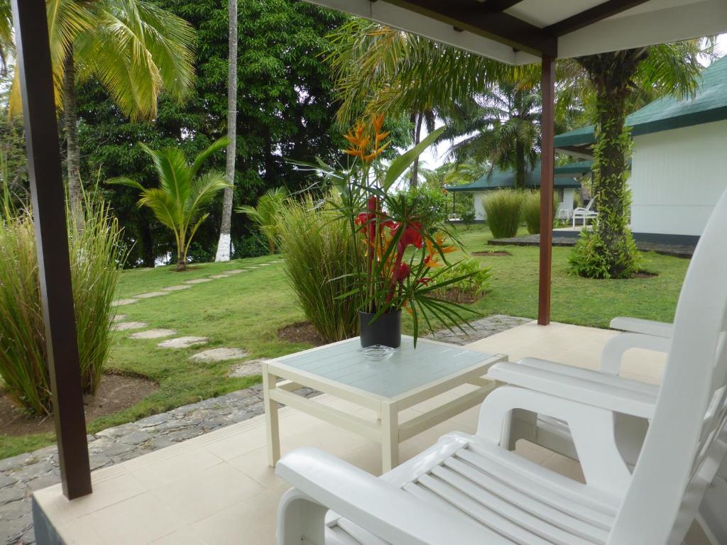 Private bungalow terrace with garden views at Club Santana, São Tomé