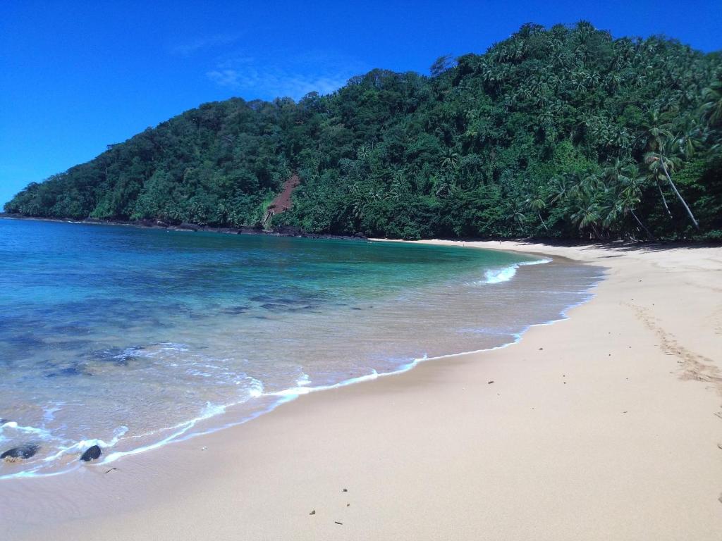 Turquoise water and empty golden sand at Praia Inhame, southern São Tomé