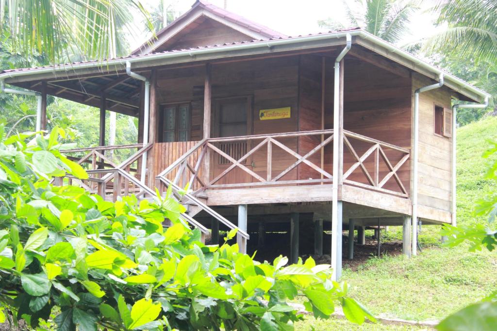 Raised wooden chalet with veranda at Praia Inhame Eco Lodge, southern São Tomé
