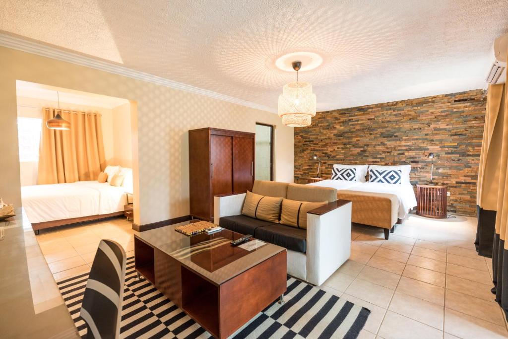 Omali Lodge family suite with two beds and lounge area, São Tomé