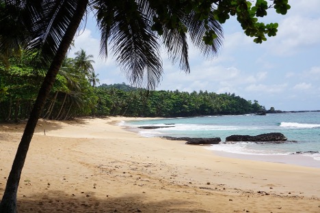 Praia Jalé wide golden-sand beach with forested headland, southern São Tomé