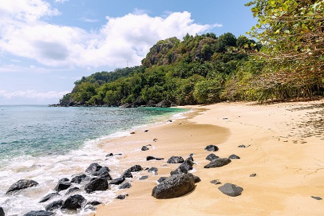 Praia Banana crescent-shaped beach on Príncipe Island, featured in Bacardi advertisements
